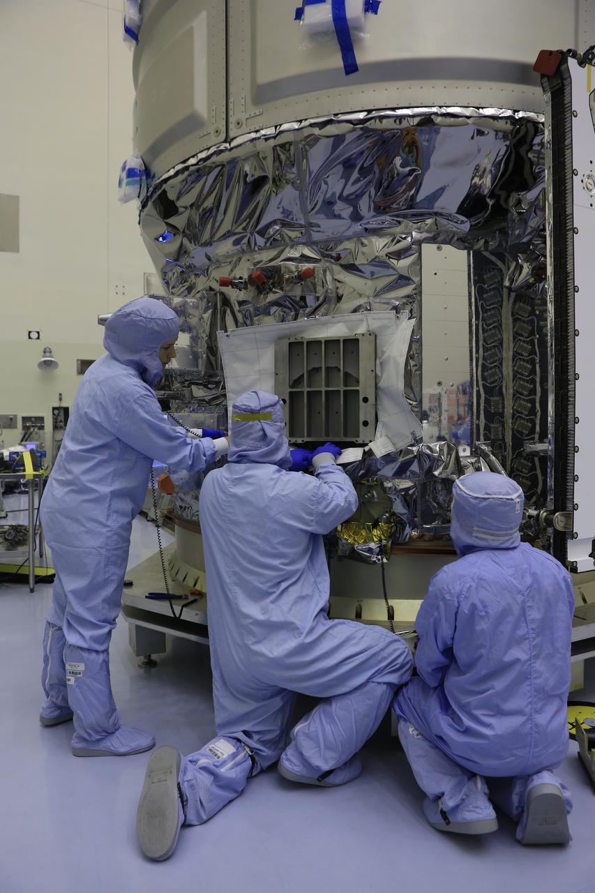 Inside the Payload Hazardous Servicing Facility at NASA's Kennedy Space Center in Florida, technicians install thermal blankets around the area where several Nanoracks will be installed on the exterior of the Orbital ATK Cygnus pressurized cargo module. The Orbital ATK CRS-7 commercial resupply services mission to the International Space Station is scheduled to launch atop a United Launch Alliance Atlas V rocket from Space Launch Complex 41 at Cape Canaveral Air Force Station no earlier than March 21, 2017. Cygnus will deliver 7,600 pounds of supplies, equipment and scientific research materials to the space station.