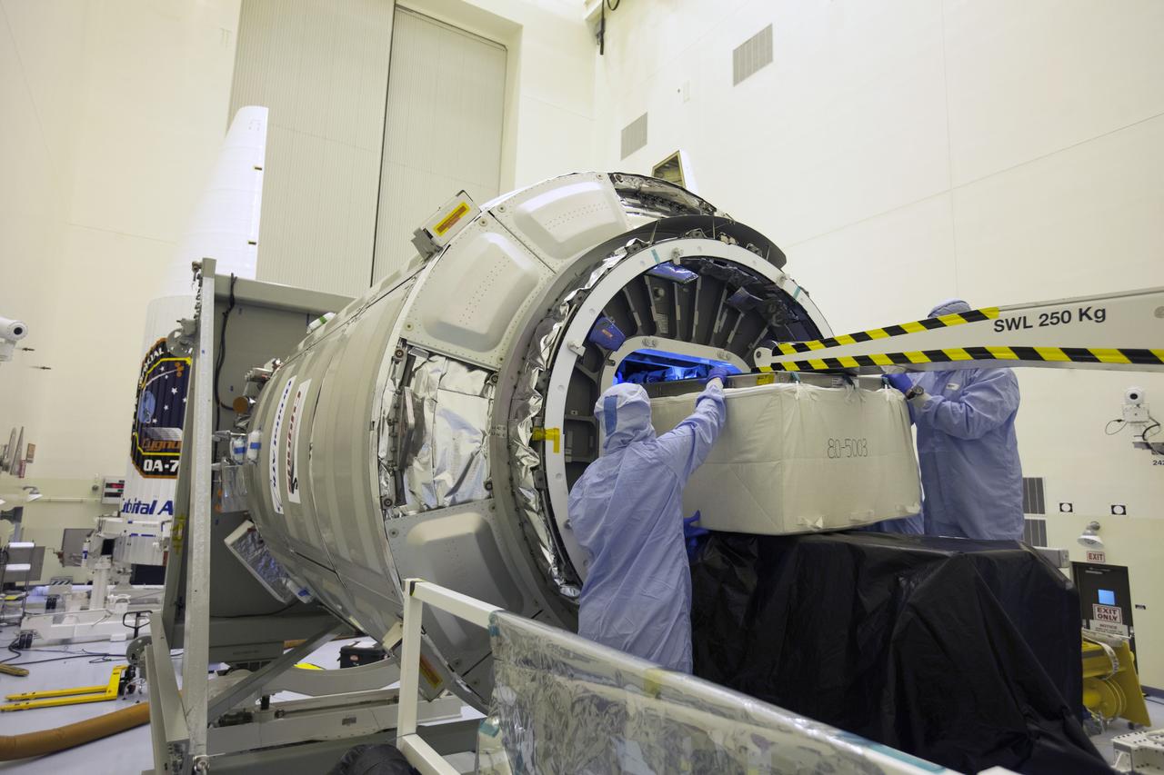 Inside the Payload Hazardous Servicing Facility at NASA's Kennedy Space Center in Florida, technicians use a special mechanism to assist with late cargo installation in the Orbital ATK Cygnus pressurized cargo module. The Orbital ATK CRS-7 commercial resupply services mission to the International Space Station is scheduled to launch atop a United Launch Alliance Atlas V rocket from Space Launch Complex 41 at Cape Canaveral Air Force Station targeted for March 24, 2017. Cygnus will deliver 7,600 pounds of supplies, equipment and scientific research materials to the space station.