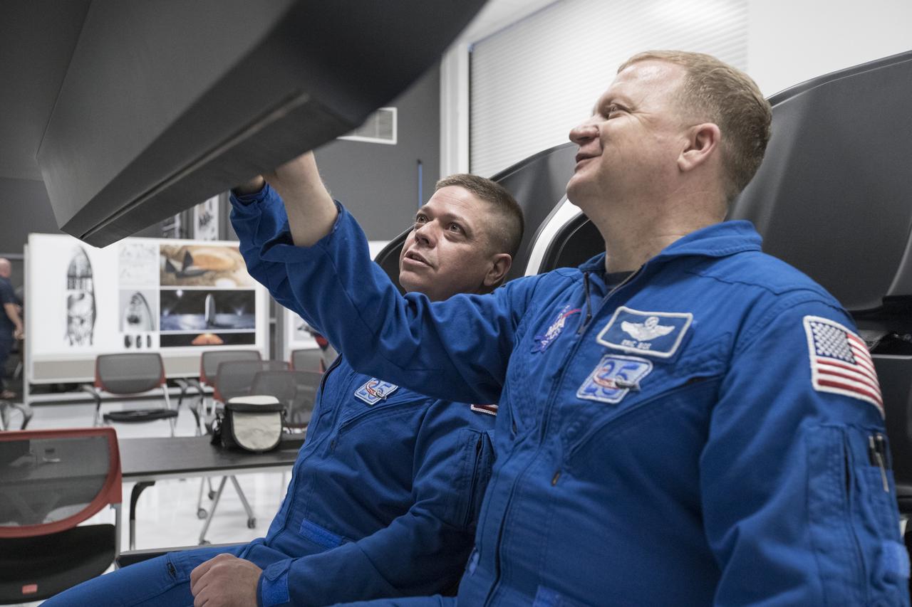 During a tour of SpaceX headquarters in Hawthorne, California, commercial crew astronauts Bob Behnken, left, and Eric Boe participate in joint test team training using mockup components of the Crew Dragon on March 8, 2017. Crew Dragon is being developed and manufactured in partnership with NASA's Commercial Crew Program to return human spaceflight capabilities to the U.S.