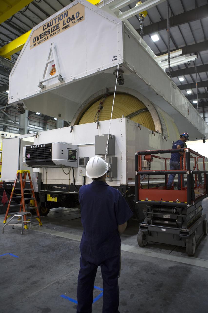 Inside the United Launch Alliance (ULA) Horizontal Integration Facility at Cape Canaveral Air Force Station in Florida, a technician assists as a crane lifts the top of the shipping container cover away from the Interim Cryogenic Propulsion Stage (ICPS) for NASA's Space Launch System rocket. The ICPS is the first integrated piece of flight hardware to arrive for the SLS. The ICPS arrived from the ULA facility in Decatur, Alabama. The ICPS is the in-space stage that is located toward the top of the rocket, between the Launch Vehicle Stage Adapter and the Orion Spacecraft Adapter. It will provide some of the in-space propulsion during Orion's first flight test atop the SLS on Exploration Mission 1.