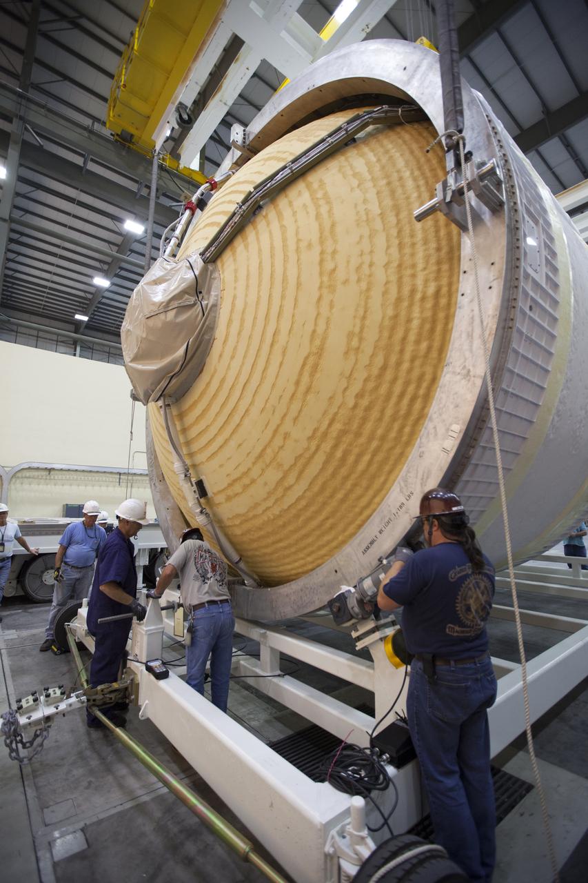 Inside the United Launch Alliance (ULA) Horizontal Integration Facility at Cape Canaveral Air Force Station in Florida, technicians help to secure the Interim Cryogenic Propulsion Stage (ICPS) for NASA's Space Launch System rocket onto a movable transport stand. The ICPS is the first integrated piece of flight hardware to arrive for the SLS. The ICPS arrived from the ULA facility in Decatur, Alabama. The ICPS is the in-space stage that is located toward the top of the rocket, between the Launch Vehicle Stage Adapter and the Orion Spacecraft Adapter. It will provide some of the in-space propulsion during Orion's first flight test atop the SLS on Exploration Mission 1. 