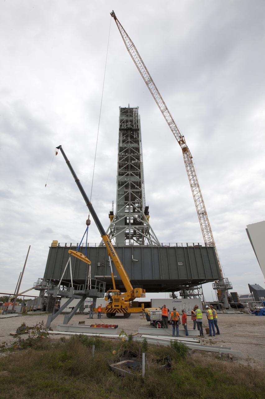 Preparations are underway to lift the bracket for the Orion Service Module Umbilical (OSMU) up for installation on the mobile launcher tower at NASA's Kennedy Space Center in Florida. The mobile launcher tower will be equipped with a number of lines, called umbilicals, that will connect to the Space Launch System rocket and Orion spacecraft for Exploration Mission-1 (EM-1). The OSMU will be located high on the mobile launcher tower and, prior to launch, will transfer liquid coolant for the electronics and air for the Environmental Control System to the Orion service module that houses these critical systems to support the spacecraft. EM-1 is scheduled to launch in 2018. The Ground Systems Development and Operations Program is overseeing installation of the umbilicals. 