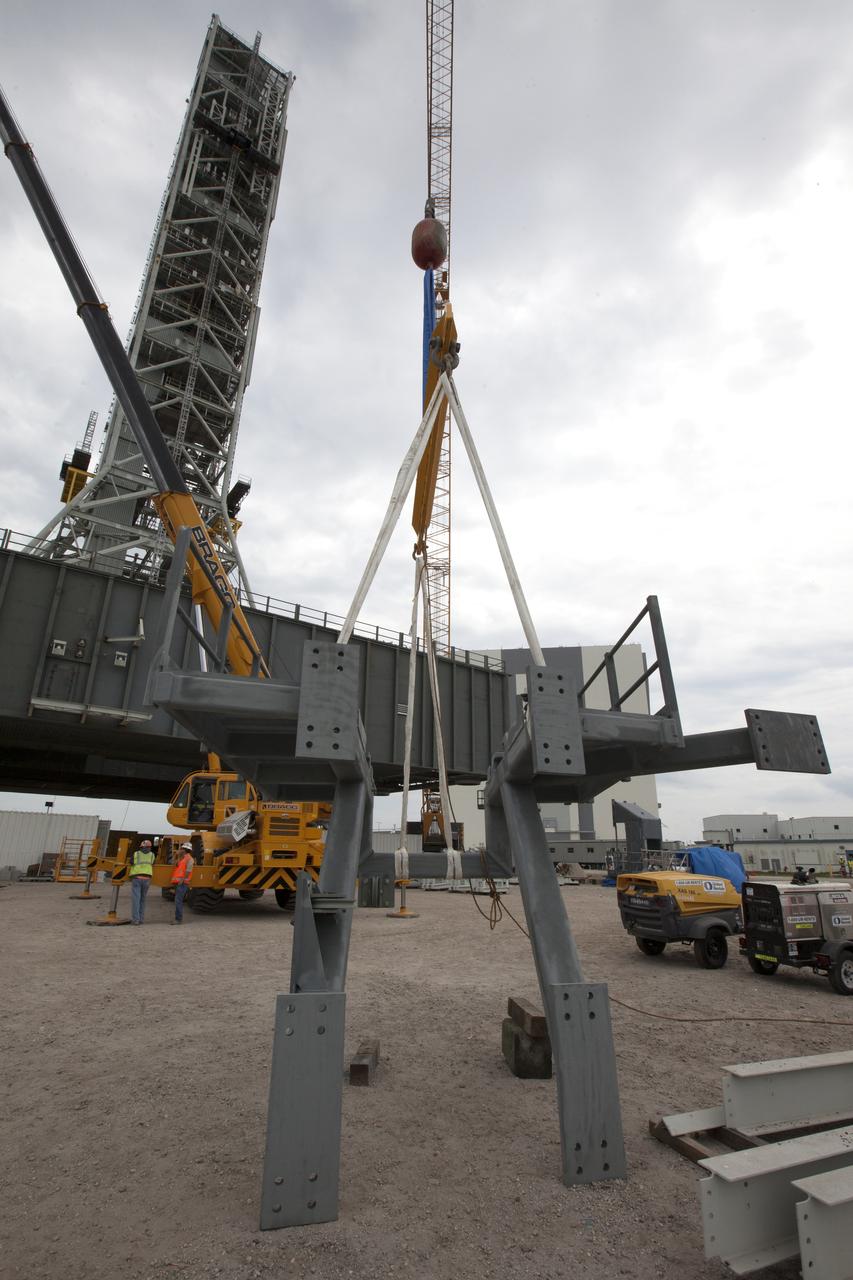 Preparations are underway to lift the bracket for the Orion Service Module Umbilical (OSMU) up for installation on the mobile launcher tower at NASA's Kennedy Space Center in Florida. The mobile launcher tower will be equipped with a number of lines, called umbilicals, that will connect to the Space Launch System rocket and Orion spacecraft for Exploration Mission-1 (EM-1). The OSMU will be located high on the mobile launcher tower and, prior to launch, will transfer liquid coolant for the electronics and air for the Environmental Control System to the Orion service module that houses these critical systems to support the spacecraft. EM-1 is scheduled to launch in 2018. The Ground Systems Development and Operations Program is overseeing installation of the umbilicals.