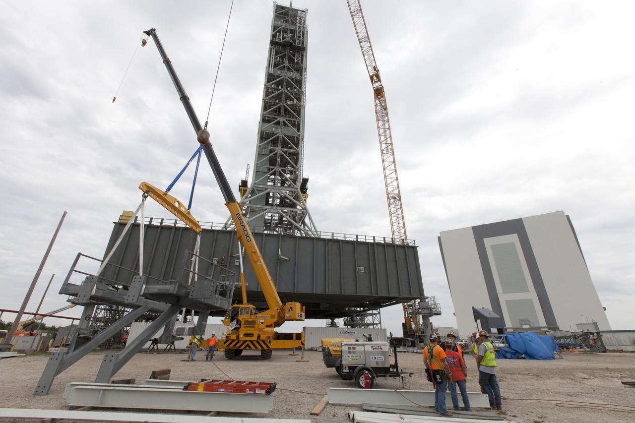 Preparations are underway to lift the bracket for the Orion Service Module Umbilical (OSMU) up for installation on the mobile launcher tower at NASA's Kennedy Space Center in Florida. The mobile launcher tower will be equipped with a number of lines, called umbilicals, that will connect to the Space Launch System rocket and Orion spacecraft for Exploration Mission-1 (EM-1). The OSMU will be located high on the mobile launcher tower and, prior to launch, will transfer liquid coolant for the electronics and air for the Environmental Control System to the Orion service module that houses these critical systems to support the spacecraft. EM-1 is scheduled to launch in 2018. The Ground Systems Development and Operations Program is overseeing installation of the umbilicals. 