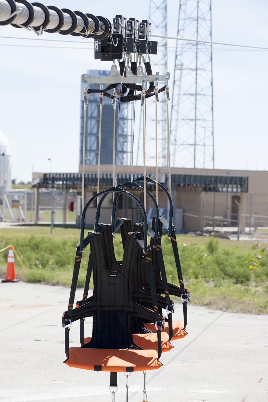 The folding seats that make up the Emergency Egress System are seen attached to slide wires at Space Launch Complex 41 where United Launch Alliance and Boeing continue modifications to the pad in order to host missions by the Boeing CST-100 Starliner carrying astronauts and crew. The system recently completed its final test. In the unlikely event of an emergency prior to liftoff, each person on the Crew Access Tower would get into their own seat attached to the wire and slide more than 1,340 feet to a safe area. The wires are situated 172 feet above the pad deck on level 12 of the tower. The Starliner will launch on a ULA Atlas V on mission to low-Earth orbit including those flying astronauts to the International Space Station during missions by NASA's Commercial Crew Program.