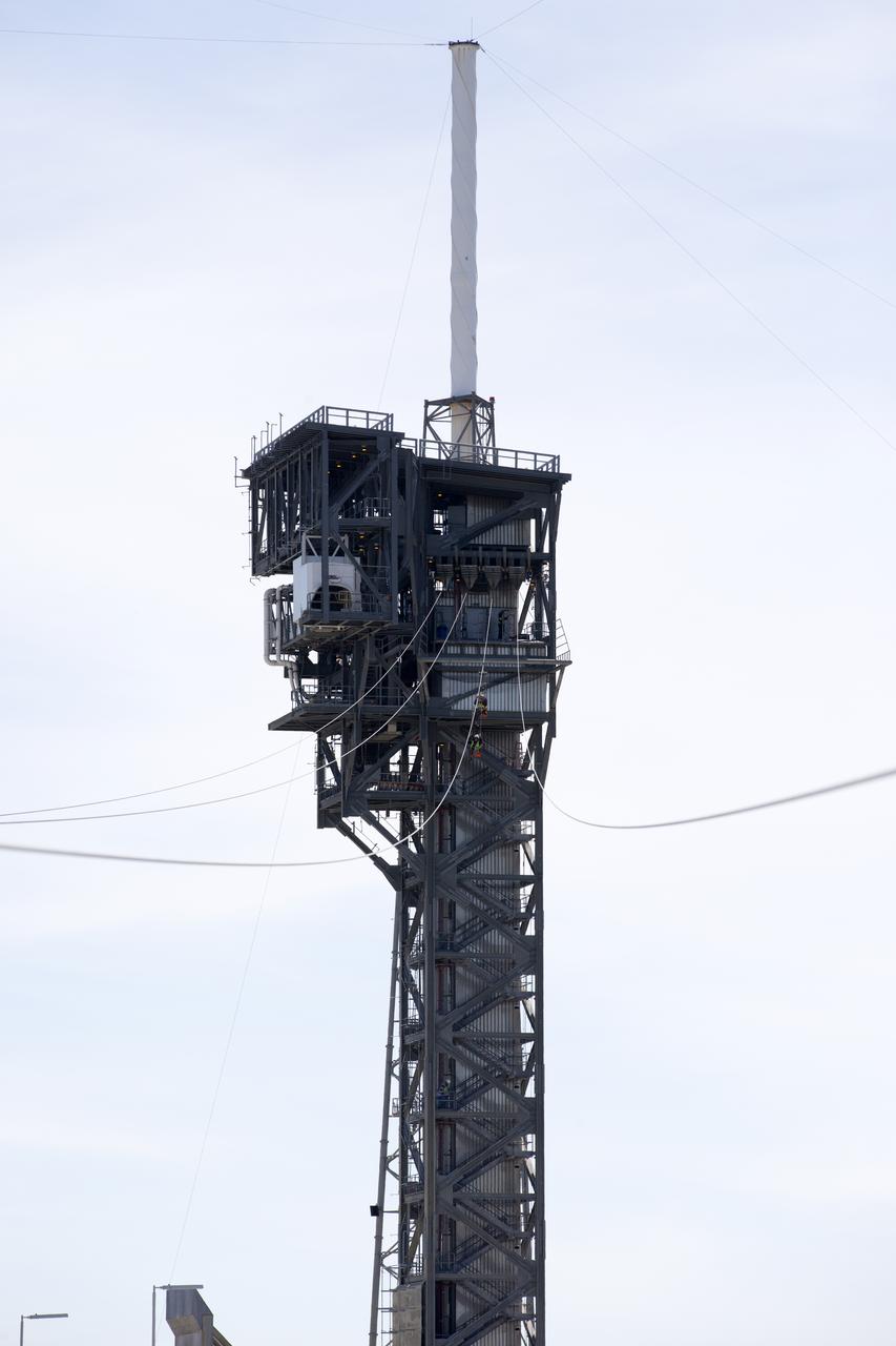 Two engineers evaluate the Emergency Egress System as they ride in folding seats attached to slide wires at Space Launch Complex 41. United Launch Alliance and Boeing continue modifications to the pad in order to host missions by the Boeing CST-100 Starliner carrying astronauts and crew. The system recently completed its final test. In the unlikely event of an emergency prior to liftoff, each person on the Crew Access Tower would get into their own seat attached to the wire and slide more than 1,340 feet to a safe area. The wires are situated 172 feet above the pad deck on level 12 of the tower. The Starliner will launch on a ULA Atlas V on mission to low-Earth orbit including those flying astronauts to the International Space Station during missions by NASA's Commercial Crew Program.