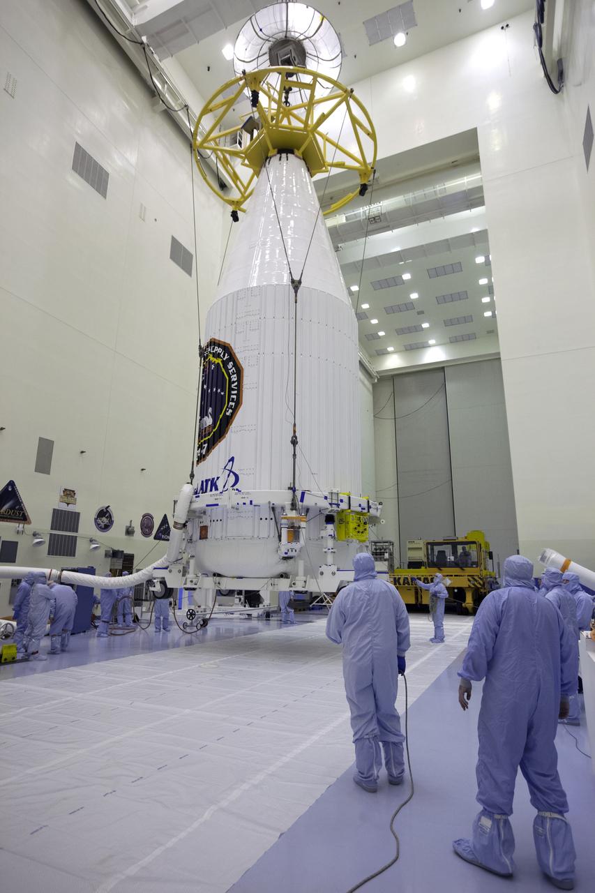 Inside the Payload Hazardous Servicing Facility at NASA's Kennedy Space Center in Florida, technicians monitor the progress as a crane is used to lift the Orbital ATK Cygnus pressurized cargo module, enclosed in its payload fairing, for transfer to a KAMAG transporter. The Orbital ATK CRS-7 commercial resupply services mission to the International Space Station is scheduled to launch atop a United Launch Alliance Atlas V rocket from Space Launch Complex 41 at Cape Canaveral Air Force Station. Cygnus will deliver 7,600 pounds of supplies, equipment and scientific research materials to the space station.
