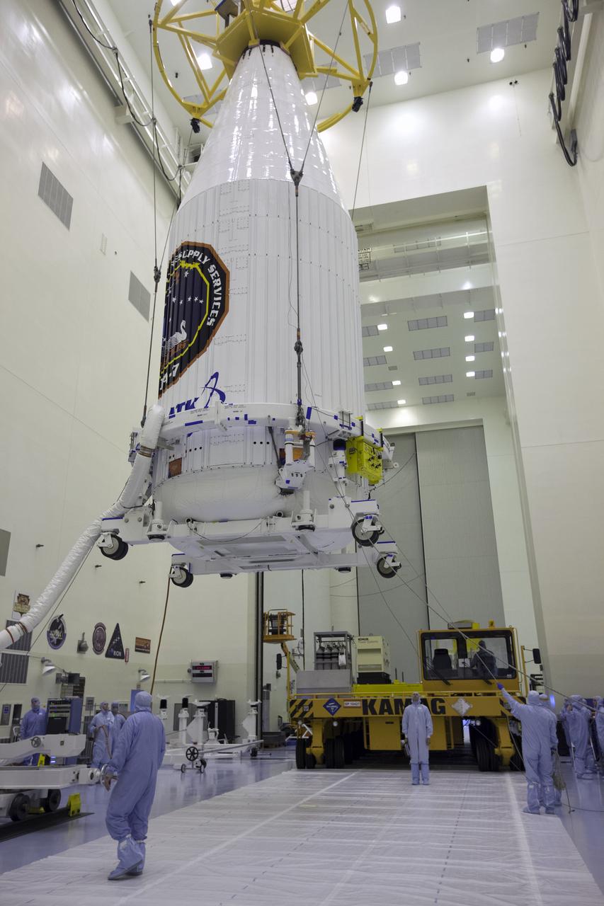 Inside the Payload Hazardous Servicing Facility at NASA's Kennedy Space Center in Florida, technicians monitor the progress as a crane is used to lift the Orbital ATK Cygnus pressurized cargo module, enclosed in its payload fairing, for transfer to a KAMAG transporter. The Orbital ATK CRS-7 commercial resupply services mission to the International Space Station is scheduled to launch atop a United Launch Alliance Atlas V rocket from Space Launch Complex 41 at Cape Canaveral Air Force Station. Cygnus will deliver 7,600 pounds of supplies, equipment and scientific research materials to the space station.