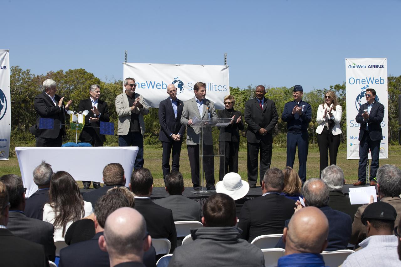 Dale Ketchum of Space Florida opens the groundbreaking ceremony at Kennedy's Exploration Park for OneWeb. The company, in partnership with Airbus, is building a 150,000-square-foot factory to manufacture satellites that will connect all areas of the world to the Internet wirelessly. Behind him are, from left, Jim Kuzma, COO of Space Florida; Mike Cosentino, president, Airbus Defense and Space; Brian Holz, CEO of OneWeb Satellites; Rick Scott, governor of Florida; Lynda Weatherman, president and CEO of the Economic Development Council of the Space Coast; Kelvin Manning, associate director of NASA's Kennedy Space Center; Gen. Wayne Monteith, commander of the 45th Space Wing of the U.S. Air Force; Cissy Procter, executive director of the Florida Department of Economic Activity; and John Saul, operations manager of Hensell-Phelps. Photo credit: NASA/Kim Shiflett