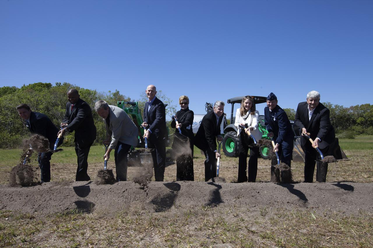 Officials break ground for a 150,000-square-foot manufacturing facility for OneWeb Satellites at Exploration Park at NASA's Kennedy Space Center. The company, in partnership with Airbus, is building a 150,000-square-foot factory to manufacture satellites that will connect all areas of the world to the Internet wirelessly. The officials are, from left, John Saul, operations manager of Hensell-Phelps; Kelvin Manning, associate director of NASA's Kennedy Space Center; Brian Holz, CEO of OneWeb Satellites; Rick Scott, governor of Florida; Lynda Weatherman, president and CEO of the Economic Development Council of the Space Coast; Mike Cosentino, president, Airbus Defense and Space; Cissy Procter, executive director of the Florida Department of Economic Activity; Gen. Wayne Monteith, commander of the 45th Space Wing of the U.S. Air Force; and Jim Kuzma, COO of Space Florida. Photo credit: NASA/Kim Shiflett