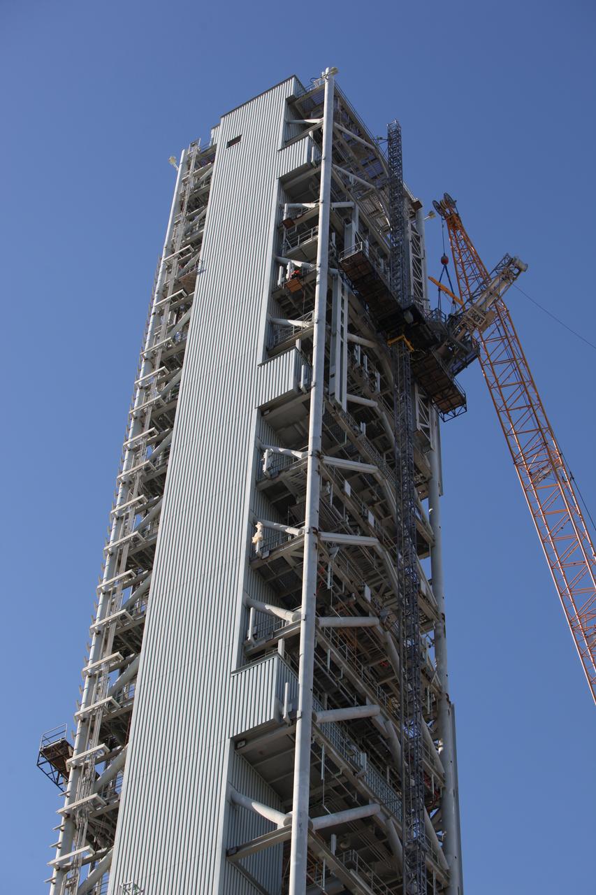 A crane and rigging are used to position the Orion Service Module Umbilical (OSMU) for installation high up on the mobile launcher tower at NASA's Kennedy Space Center in Florida. The mobile launcher tower will be equipped with a number of lines, called umbilicals, that will connect to the Space Launch System rocket and Orion spacecraft for Exploration Mission-1 (EM-1). The OSMU will be located high on the mobile launcher tower and, prior to launch, will transfer liquid coolant for the electronics and air for the Environmental Control System to the Orion service module that houses these critical systems to support the spacecraft. EM-1 is scheduled to launch in 2018. The Ground Systems Development and Operations Program is overseeing installation of the umbilicals. 