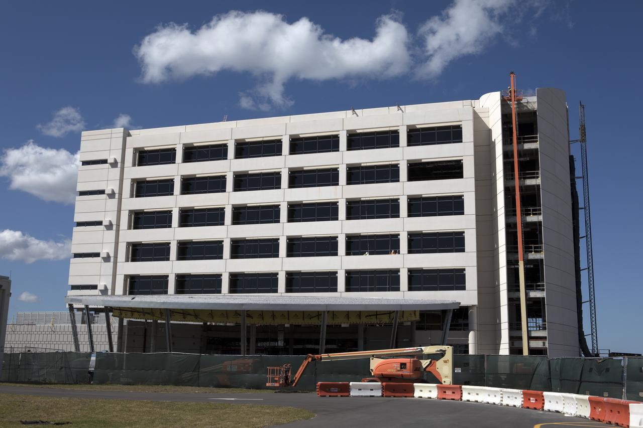 NASA's Kennedy Space Center in Florida is a premier, multi-user spaceport with ongoing construction adding new, ultra-modern facilities. A key element of the Central Campus makeover is a new, seven-story, 200,000-square-foot headquarters building that has taken shape in the heart of the spaceport. The headquarters building's glass facade, as seen from NASA Causeway, is complete. The exterior skin of the building also is nearly finished. The remainder of the glass components are being installed on each floor. Construction of interior walls and utilities on most floors is well underway. Construction of the headquarters building is targeted for completion in November 2017 and employees are expected to be able to move in soon after.
