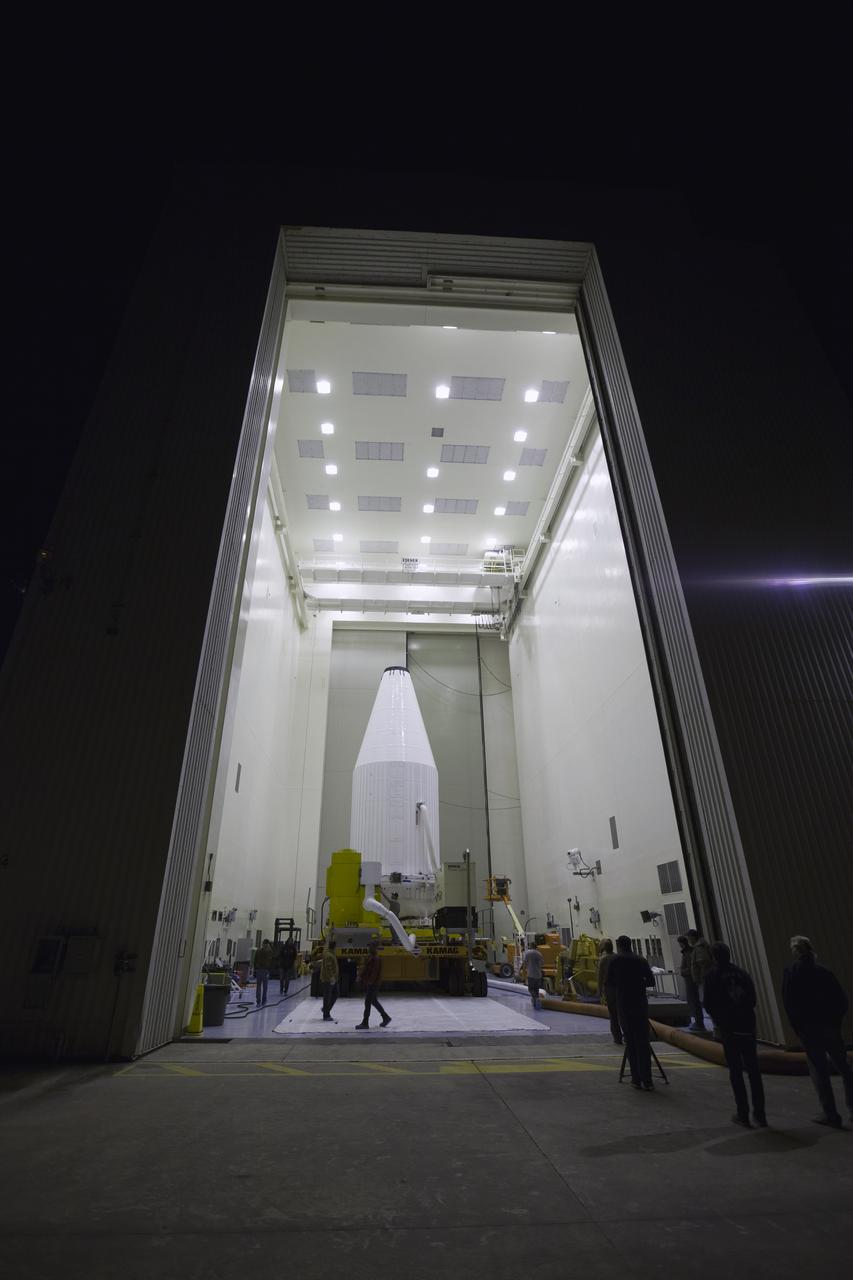 The Orbital ATK Cygnus pressurized cargo module, enclosed in its payload fairing, is secured on a KAMAG transporter and ready to depart the Payload Hazardous Servicing Facility at NASA's Kennedy Space Center in Florida. Cygnus will be transported to Space Launch Complex 41 at Cape Canaveral Air Force Station for mating to the United Launch Alliance (ULA) Atlas V rocket. The Orbital ATK CRS-7 commercial resupply services mission to the International Space Station is scheduled to launch atop the Atlas V from pad 41. Cygnus will deliver 7,600 pounds of supplies, equipment and scientific research materials to the space station. 