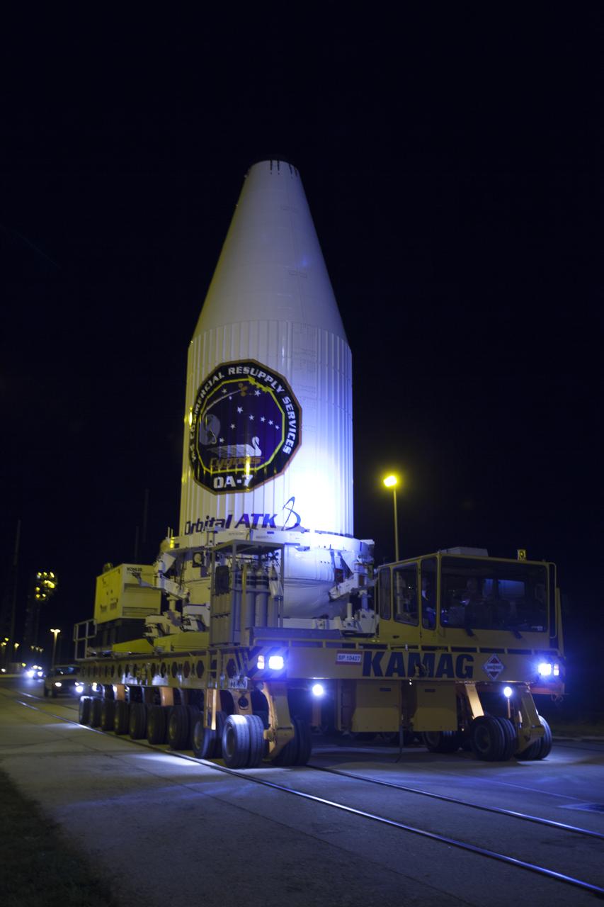 A spotlight shines on the payload fairing containing the Orbital ATK Cygnus pressurized cargo module as a KAMAG transporter moves along the road toward Space Launch Complex 41 at Cape Canaveral Air Force Station in Florida. Cygnus will be mated to the United Launch Alliance (ULA) Atlas V rocket. The Orbital ATK CRS-7 commercial resupply services mission to the International Space Station is scheduled to launch atop the Atlas V rocket from pad 41. Cygnus will deliver 7,600 pounds of supplies, equipment and scientific research materials to the space station.