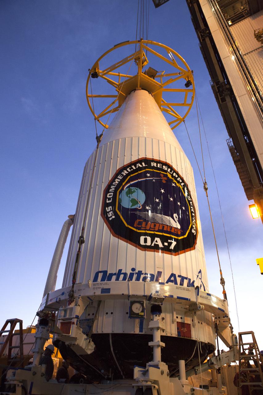 The payload fairing containing the Orbital ATK Cygnus pressurized cargo module is lifted by crane at the United Launch Alliance (ULA) Vertical Integration Facility at Space Launch Complex 41 at Cape Canaveral Air Force Station in Florida. The payload will be hoisted up and mated to the ULA Atlas V rocket. The Orbital ATK CRS-7 commercial resupply services mission to the International Space Station is scheduled to launch atop the Atlas V from pad 41. Cygnus will deliver 7,600 pounds of supplies, equipment and scientific research materials to the space station. 