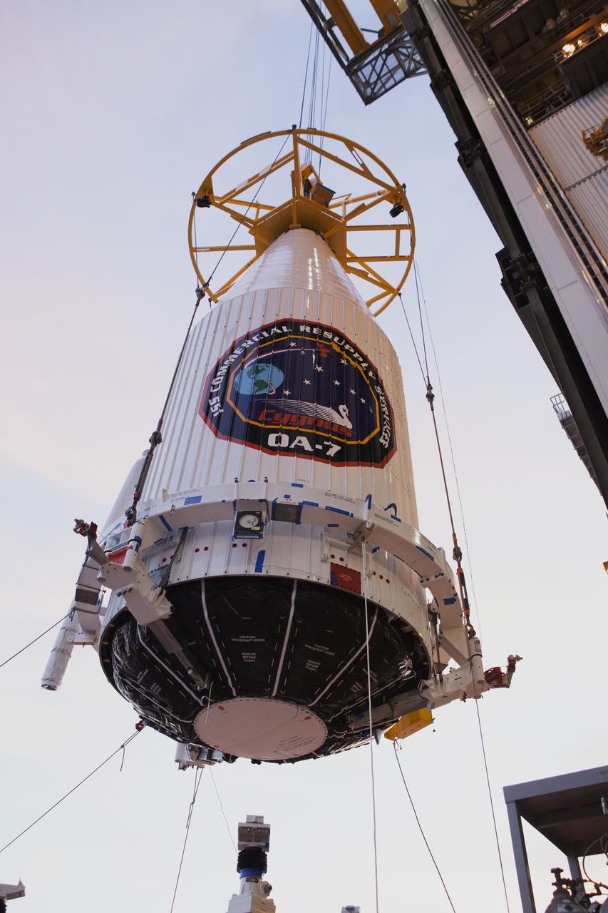 The payload fairing containing the Orbital ATK Cygnus pressurized cargo module is lifted by crane at the United Launch Alliance (ULA) Vertical Integration Facility at Space Launch Complex 41 at Cape Canaveral Air Force Station in Florida. The payload will be hoisted up and mated to the ULA Atlas V rocket. The Orbital ATK CRS-7 commercial resupply services mission to the International Space Station is scheduled to launch atop the Atlas V from pad 41. Cygnus will deliver 7,600 pounds of supplies, equipment and scientific research materials to the space station. 
