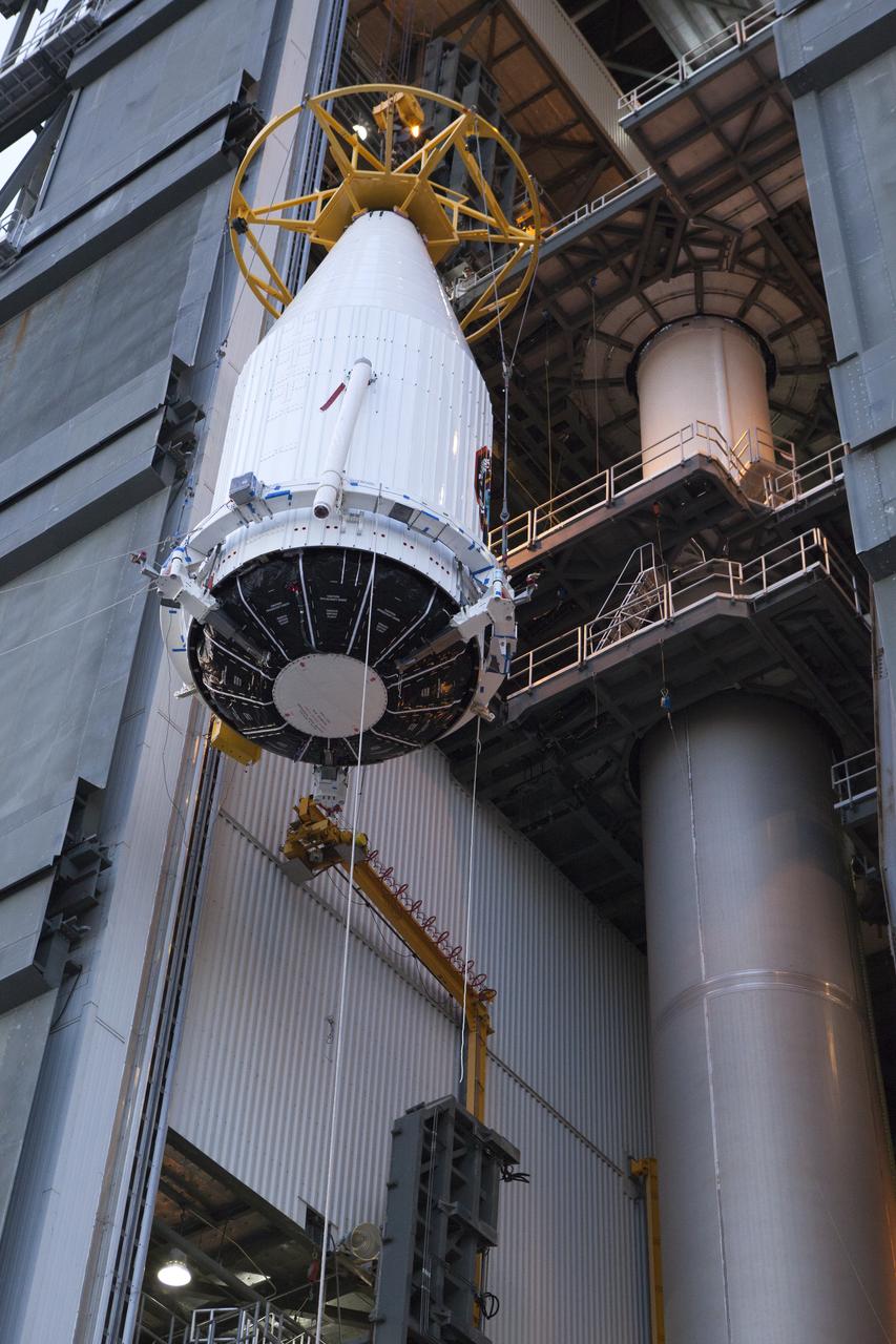 The payload fairing containing the Orbital ATK Cygnus pressurized cargo module is lifted by crane at the United Launch Alliance (ULA) Vertical Integration Facility at Space Launch Complex 41 at Cape Canaveral Air Force Station in Florida. The payload will be hoisted up and mated to the ULA Atlas V rocket. The Orbital ATK CRS-7 commercial resupply services mission to the International Space Station is scheduled to launch atop the Atlas V from pad 41. Cygnus will deliver 7,600 pounds of supplies, equipment and scientific research materials to the space station.