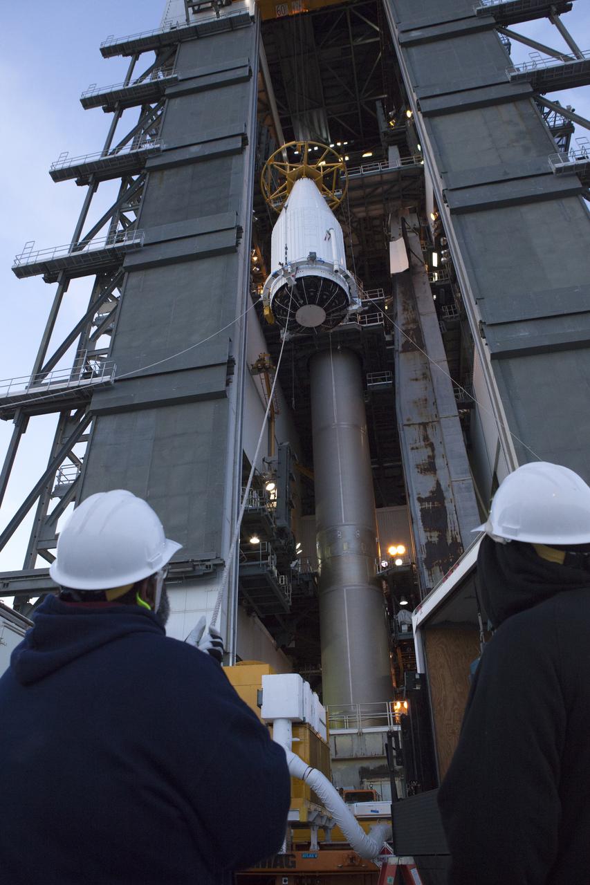 The payload fairing containing the Orbital ATK Cygnus pressurized cargo module is hoisted up by crane at the United Launch Alliance (ULA) Vertical Integration Facility at Space Launch Complex 41 at Cape Canaveral Air Force Station in Florida. The payload will be mated to the ULA Atlas V rocket. The Orbital ATK CRS-7 commercial resupply services mission to the International Space Station is scheduled to launch atop the Atlas V from pad 41. Cygnus will deliver 7,600 pounds of supplies, equipment and scientific research materials to the space station. 