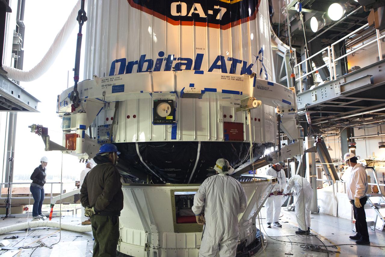 United Launch Alliance (ULA) technicians monitor the progress as the payload fairing containing the Orbital ATK Cygnus pressurized cargo module is lowered onto the Centaur upper stage, or second stage, of the ULA Atlas V rocket in the Vertical Integration Facility at Space Launch Complex 41 at Cape Canaveral Air Force Station in Florida. The Orbital ATK CRS-7 commercial resupply services mission to the International Space Station is scheduled to launch atop the Atlas V from pad 41. Cygnus will deliver 7,600 pounds of supplies, equipment and scientific research materials to the space station.