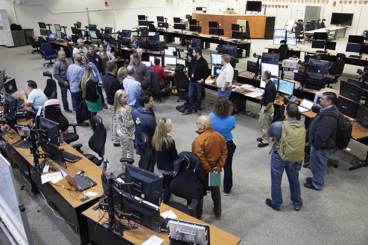 NASA engineers and test directors gather in Firing Room 3 in the Launch Control Center at NASA's Kennedy Space Center in Florida, to watch a demonstration of the automated command and control software for the agency's Space Launch System (SLS) and Orion spacecraft. The software is called the Ground Launch Sequencer. It will be responsible for nearly all of the launch commit criteria during the final phases of launch countdowns. The Ground and Flight Application Software Team (GFAST) demonstrated the software. It was developed by the Command, Control and Communications team in the Ground Systems Development and Operations (GSDO) Program. GSDO is helping to prepare the center for the first test flight of Orion atop the SLS on Exploration Mission 1. 