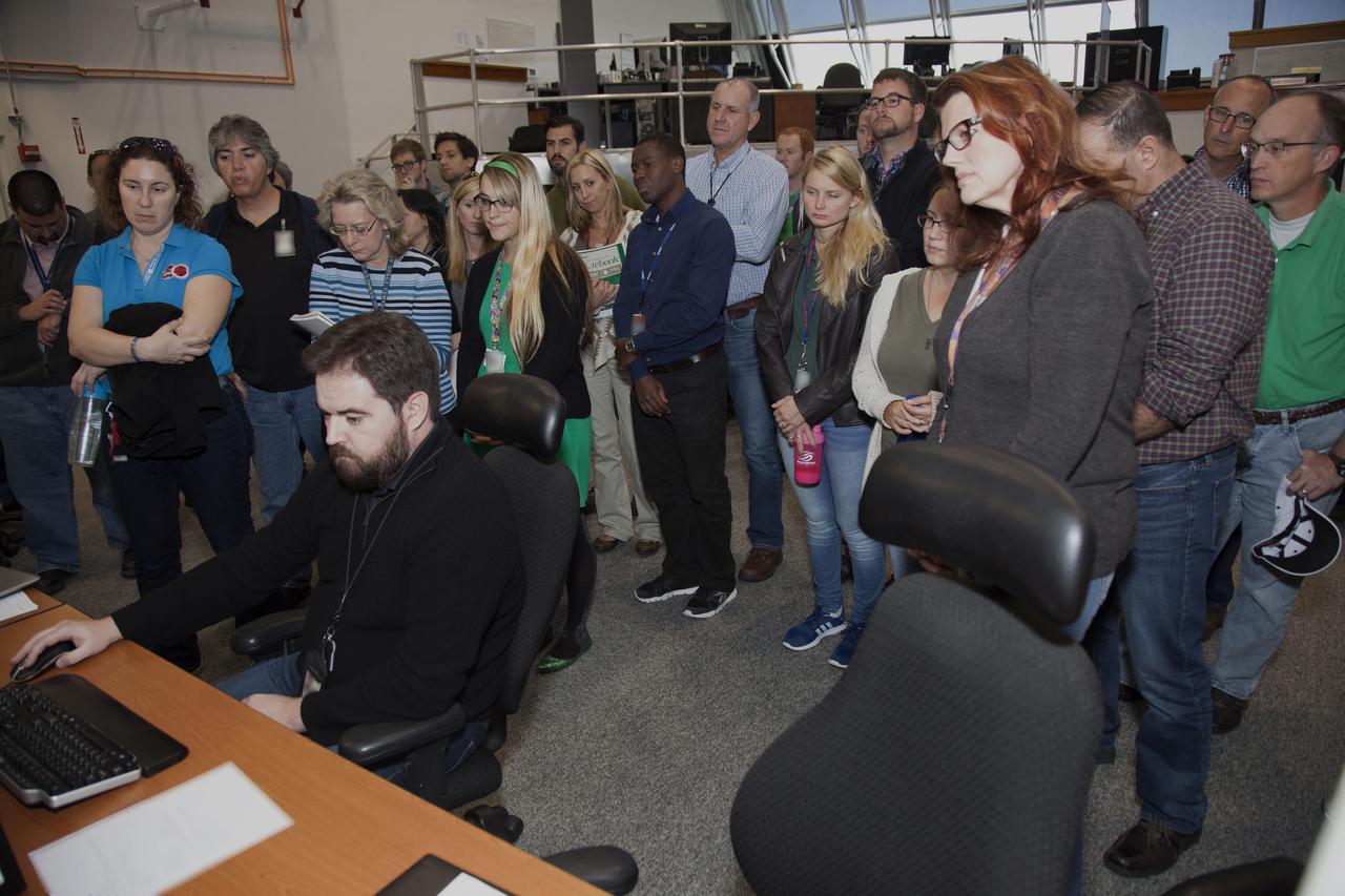 NASA engineers and test directors gather in Firing Room 3 in the Launch Control Center at NASA's Kennedy Space Center in Florida, to watch a demonstration of the automated command and control software for the agency's Space Launch System (SLS) and Orion spacecraft. In front, far right, is Charlie Blackwell-Thompson, launch director for Exploration Mission 1 (EM-1). The software is called the Ground Launch Sequencer. It will be responsible for nearly all of the launch commit criteria during the final phases of launch countdowns. The Ground and Flight Application Software Team (GFAST) demonstrated the software. It was developed by the Command, Control and Communications team in the Ground Systems Development and Operations (GSDO) Program. GSDO is helping to prepare the center for the first test flight of Orion atop the SLS on EM-1.