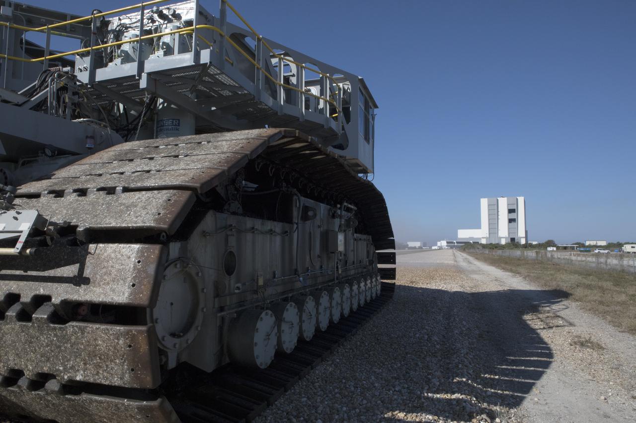 Crawler-transporter 2 (CT-2) moves slowly along the crawlerway toward the Vehicle Assembly Building (in the background) at NASA's Kennedy Space Center in Florida. The crawler took a trip to the Pad A/B split to test upgrades recently completed that will allow the giant vehicle to handle the load of the agency's Space Launch System rocket and Orion spacecraft atop the mobile launcher. The Ground Systems Development and Operations Program oversaw upgrades to the 50-year-old CT-2. New generators, gear assemblies, jacking, equalizing and leveling (JEL) hydraulic cylinders, roller bearings and brakes were installed, and other components were upgraded to prepare for Exploration Mission 1. 