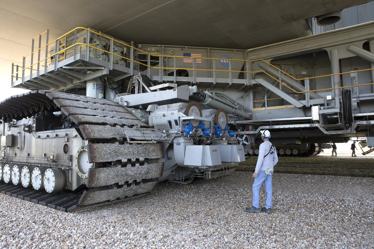 During a load test of NASA's upgraded crawler-transporter 2 (CT-2), a ground support technician watches as the giant vehicle travels along the crawlerway at the agency’s Kennedy Space Center in Florida. The crawler's upgrades and modifications will be monitored and tested under loaded conditions during its travel to the crawlerway Pad A/B split and back to the crawler yard to confirm it is ready to support the load of the mobile launcher carrying the Space Launch System with Orion atop for the first test flight, Exploration Mission 1. The Ground Systems Development and Operations Program at Kennedy is managing upgrades to the crawler. 