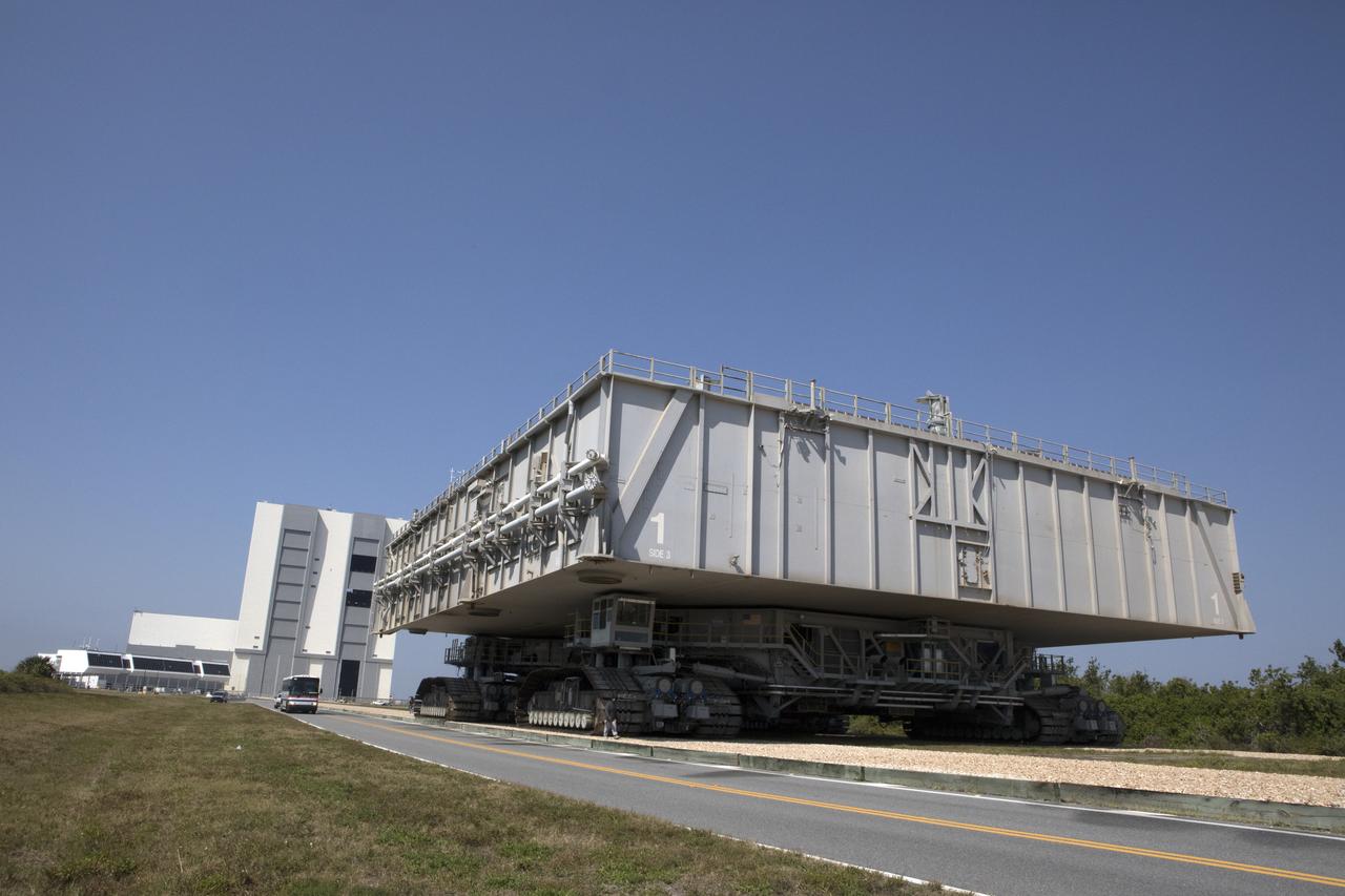 NASA's upgraded crawler-transporter 2 (CT-2), carrying mobile launcher platform 1, moves slowly along the crawlerway toward the Vehicle Assembly Building at the agency's Kennedy Space Center in Florida. The crawler's upgrades and modifications were monitored and tested during a loaded test to the crawlerway Pad A/B split. CT-2 will return to the crawler yard. The crawler is being tested to confirm it is ready to support the load of the mobile launcher carrying the Space Launch System with Orion atop for the first test flight, Exploration Mission 1. The Ground Systems Development and Operations Program at Kennedy is managing upgrades to the crawler. 