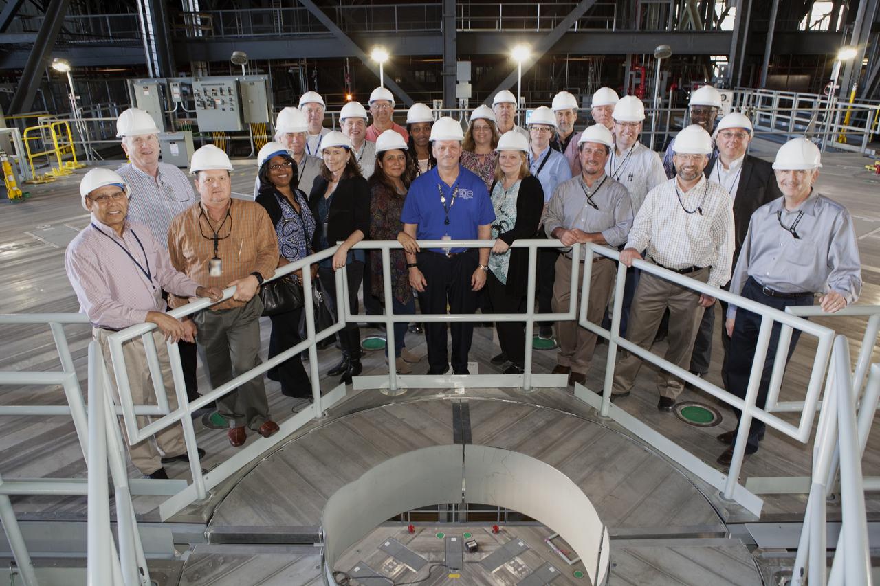 Members of NASA’s Engineering Management Board pause for a group photo during a tour of the Vehicle Assembly Building at Kennedy Space Center in Florida. The platforms in High Bay 3, including the one on which the board members are standing, were designed to surround and provide access to NASA’s Space Launch System and Orion spacecraft. The Engineering Management Board toured integral areas of Kennedy to help the agencywide group reach its goal of unifying engineering work across NASA.