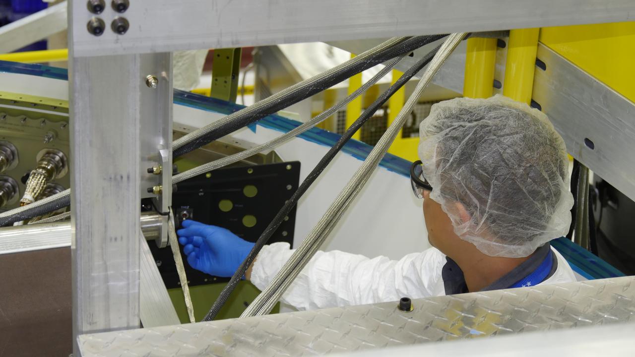 An engineer works the switch to power on a Boeing CST-100 Starliner spacecraft inside Boeing's Commercial Crew and Cargo Processing Facility at NASA's Kennedy Space Center in Florida. This was the first time "Spacecraft 1," as the individual Starliner is known, was powered up. It is being assembled for use during a pad abort test that will demonstrate the Starliners' ability to lift astronauts out of danger in the unlikely event of an emergency. Later flight tests will demonstrate Starliners in orbital missions to the station without a crew, and then with astronauts aboard. The flight tests will preview the crew rotation missions future Starliners will perform as they take up to four astronauts at a time to the orbiting laboratory in order to enhance the research taking place there.