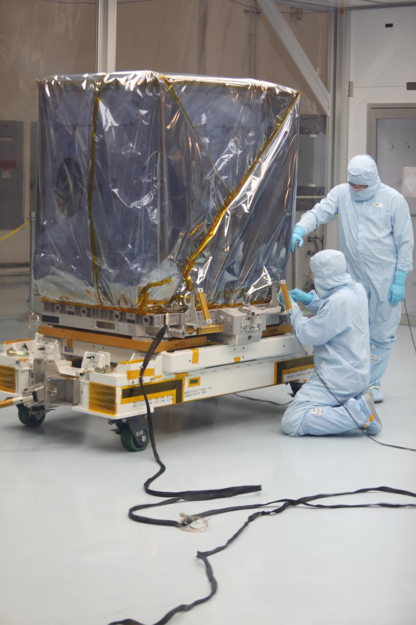 Inside the Space Station Processing Facility high bay at NASA's Kennedy Space Center in Florida, technicians prepare the Neutron star Interior Composition Explorer, or NICER, payload for final packaging. NICER will be delivered to the International Space Station aboard the SpaceX Dragon cargo carrier on the company’s 11th commercial resupply services mission to the space station. NICER will study neutron stars through soft X-ray timing. NICER will enable rotation-resolved spectroscopy of the thermal and non-thermal emissions of neutron stars in the soft X-ray band with unprecedented sensitivity, probing interior structure, the origins of dynamic phenomena and the mechanisms that underlie the most powerful cosmic particle accelerators known.