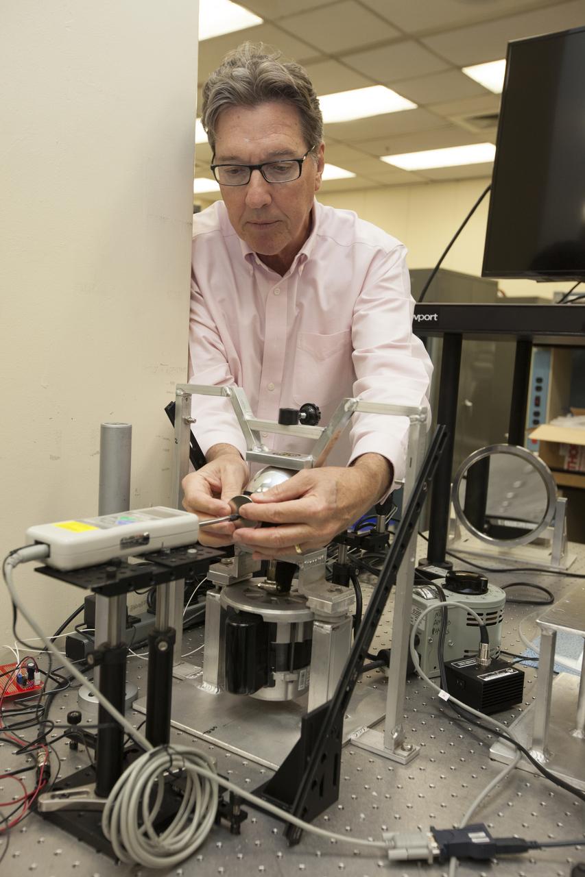 Physicist Stan Starr works with a magnetic sphere in a laboratory at NASA's Kennedy Space Center in Florida.