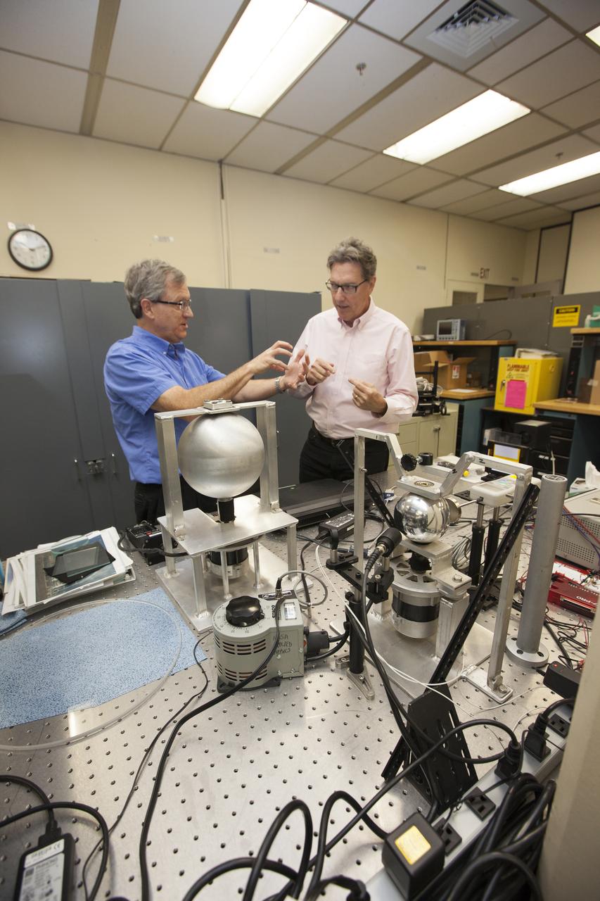 Physicists Bob Youngquist, left, and Stan Starr work with hollow and solid metal spheres in a laboratory at NASA's Kennedy Space Center in Florida where they are helping formulate principles of magnetic forces to see how they might be applied to spaceflight.