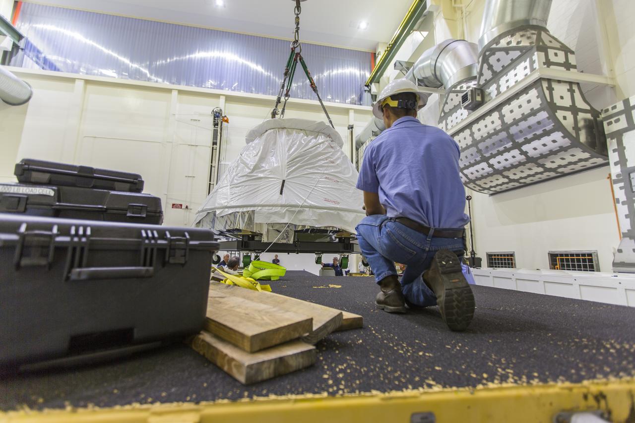 Inside the Neil Armstrong Operations and Checkout Building at NASA's Kennedy Space Center in Florida, Lockheed Martin workers prepare the Orion crew module from Exploration Flight Test 1 for its move to the nearby Kennedy Space Center Visitor Complex. The crew module will be delivered to the IMAX Theater where it will be prepared for display in the NASA Now exhibit. The Orion spacecraft launched atop a United Launch Alliance Delta IV rocket Dec. 5, 2014, from Space Launch Complex 37 at Cape Canaveral Air Force Station. The spacecraft built for humans traveled 3,604 miles above Earth and splashed down about 4.5 hours later in the Pacific Ocean. 