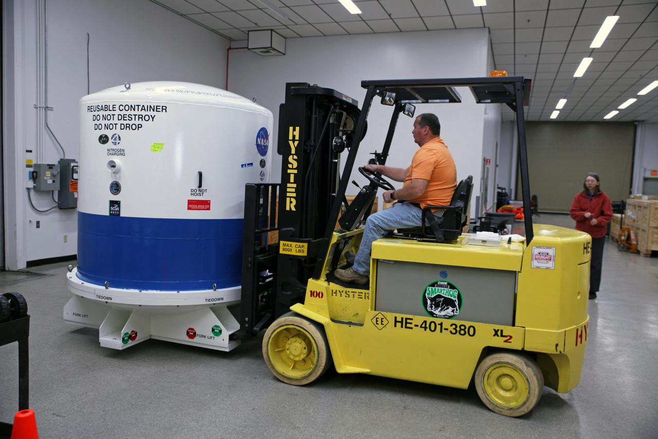 Inside the Space Station Processing Facility high bay at NASA's Kennedy Space Center in Florida, the Neutron star Interior Composition Explorer, or NICER, payload is secured inside a protective container. A technician uses a Hyster forklift to pick up the container and move it outside of the high bay. NICER will be delivered to the International Space Station aboard the SpaceX Dragon cargo carrier on the company’s 11th commercial resupply services mission to the space station. NICER will study neutron stars through soft X-ray timing. NICER will enable rotation-resolved spectroscopy of the thermal and non-thermal emissions of neutron stars in the soft X-ray band with unprecedented sensitivity, probing interior structure, the origins of dynamic phenomena and the mechanisms that underlie the most powerful cosmic particle accelerators known.