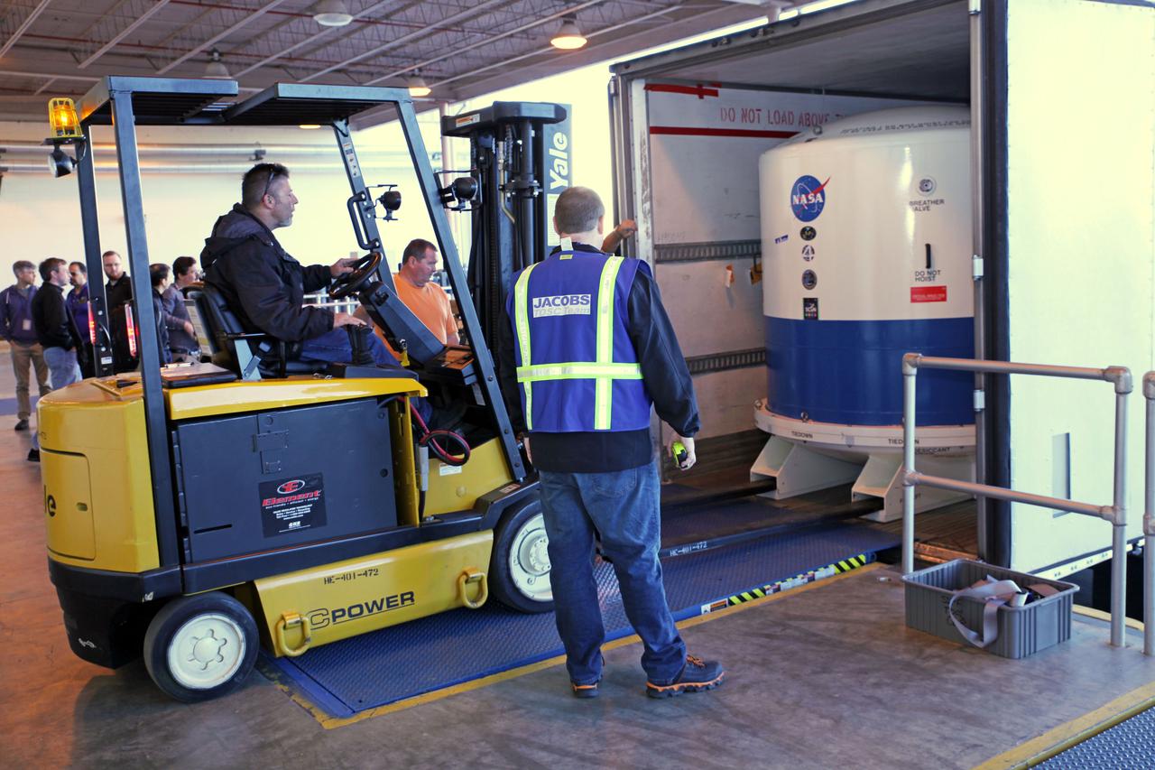 Inside the Space Station Processing Facility high bay at NASA's Kennedy Space Center in Florida, the Neutron star Interior Composition Explorer, or NICER, payload is secured inside a protective container and loaded onto a truck outside the high bay. NICER will be delivered to the International Space Station aboard the SpaceX Dragon cargo carrier on the company’s 11th commercial resupply services mission to the space station. NICER will study neutron stars through soft X-ray timing. NICER will enable rotation-resolved spectroscopy of the thermal and non-thermal emissions of neutron stars in the soft X-ray band with unprecedented sensitivity, probing interior structure, the origins of dynamic phenomena and the mechanisms that underlie the most powerful cosmic particle accelerators known. 