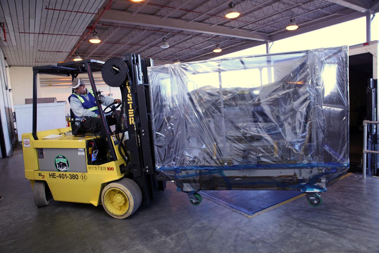 Outside the Space Station Processing Facility high bay at NASA's Kennedy Space Center in Florida, a technician uses a Hyster forklift to carry the Roll-Out Solar Array, or ROSA, to the loading dock. ROSA will be delivered to the International Space Station aboard the SpaceX Dragon cargo carrier on the company’s 11th commercial resupply services mission to the space station. ROSA is a new type of solar panel that rolls open in space and is more compact than current rigid panel designs. The ROSA investigation will test deployment and retraction, shape changes when the Earth blocks the sun, and other physical challenges to determine the array's strength and durability.