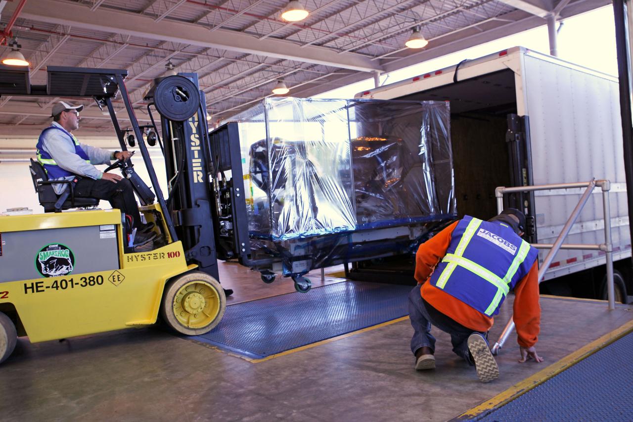 At the loading dock outside the Space Station Processing Facility high bay at NASA's Kennedy Space Center in Florida, a technician uses a Hyster forklift to load the Roll-Out Solar Array, or ROSA, into a truck. ROSA will be delivered to the International Space Station aboard the SpaceX Dragon cargo carrier on the company’s 11th commercial resupply services mission to the space station. ROSA is a new type of solar panel that rolls open in space and is more compact than current rigid panel designs. The ROSA investigation will test deployment and retraction, shape changes when the Earth blocks the sun, and other physical challenges to determine the array's strength and durability.