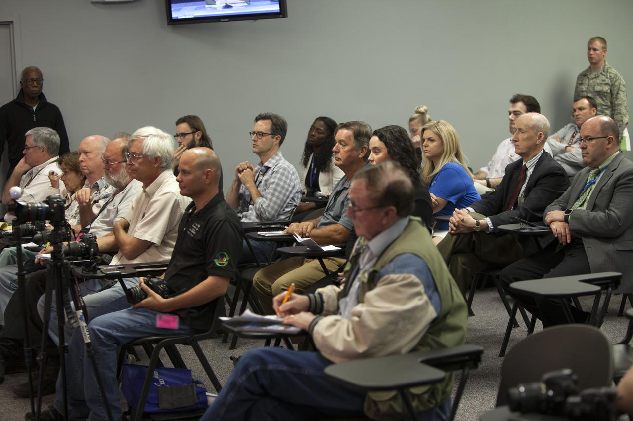 Members of the media listen to a prelaunch status briefing for Orbital ATK's seventh commercial resupply mission, CRS-7, to the International Space Station, at NASA Kennedy Space Center's Press Site in Florida. Moderating the briefing is  George Diller, NASA Kennedy Public Affairs. Participants in the briefing are Joel Montalbano, deputy manager, NASA International Space Station Program; Vern Thorp, program manager, commercial missions, United Launch Alliance; Frank Culbertson, Space Systems Group president, Orbital ATK; Tara Ruttley, Johnson Space Center Program Science Office; and David Craft, weather officer, 45th Weather Squadron. Orbital ATK's Cygnus pressurized cargo module is set to launch atop the ULA Atlas V rocket from Space Launch Complex 41 at Cape Canaveral Air Force Station on April 18. Cygnus will deliver 7,600 pounds of supplies, equipment and scientific research materials to the space station. Liftoff is scheduled for 11:11 a.m. EDT. 
