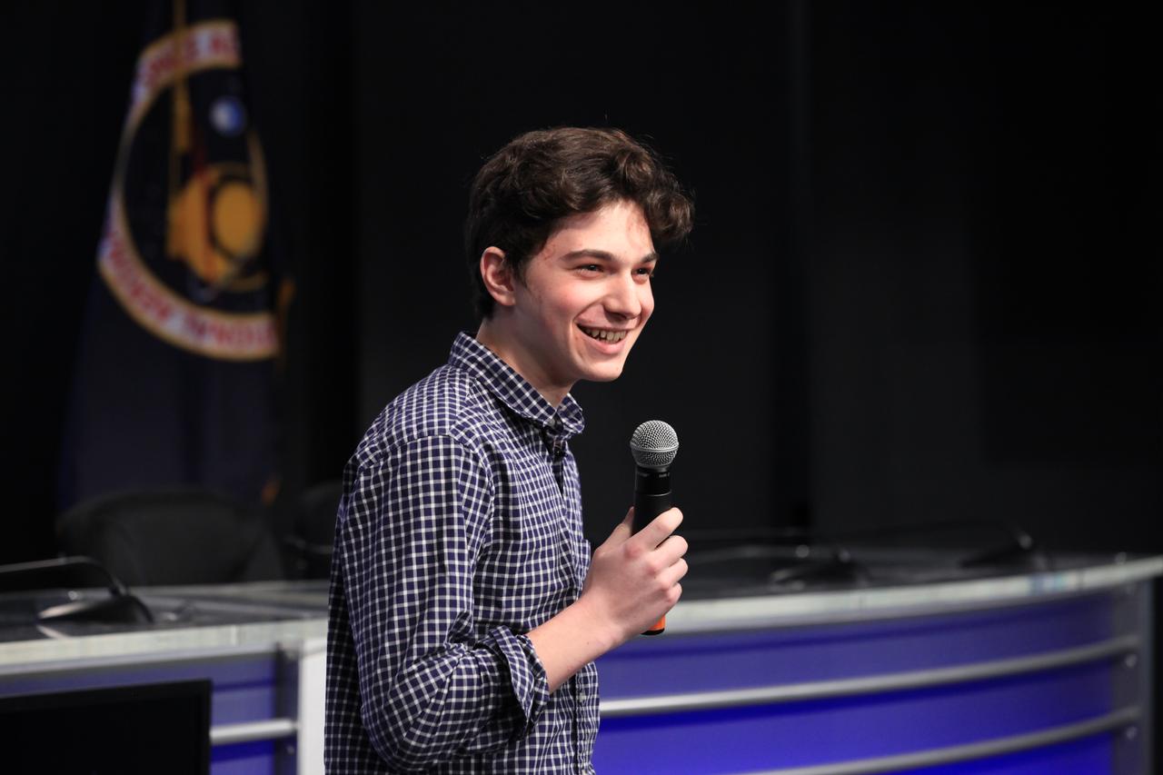 Julian Rubinfien, student winner of the Genes in Space competition, discusses his Genes in Space II winning experiment during a "What's on Board" science briefing to NASA Social participants at NASA's Kennedy Space Center in Florida. The briefing was for Orbital ATK's seventh commercial resupply services mission, CRS-7, to the International Space Station. Orbital ATK's Cygnus pressurized cargo module is set to launch on the United Launch Alliance Atlas V rocket from Space Launch Complex 41 at Cape Canaveral Air Force Station on April 18. Liftoff is scheduled for 11:11 a.m. EDT. 