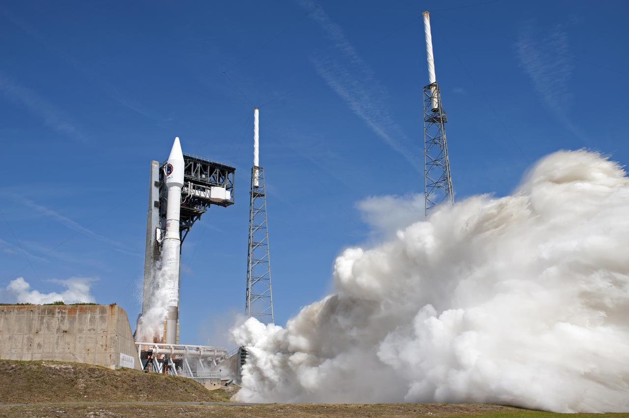 With blue sky for a background, the Orbital ATK Cygnus pressurized cargo module is carried atop the United Launch Alliance Atlas V rocket from Space Launch Complex 41 at Cape Canaveral Air Force Station in Florida. Orbital ATK's seventh commercial resupply services mission, CRS-7, will deliver 7,600 pounds of supplies, equipment and scientific research materials to the International Space Station. Liftoff was at 11:11 a.m. EDT. 