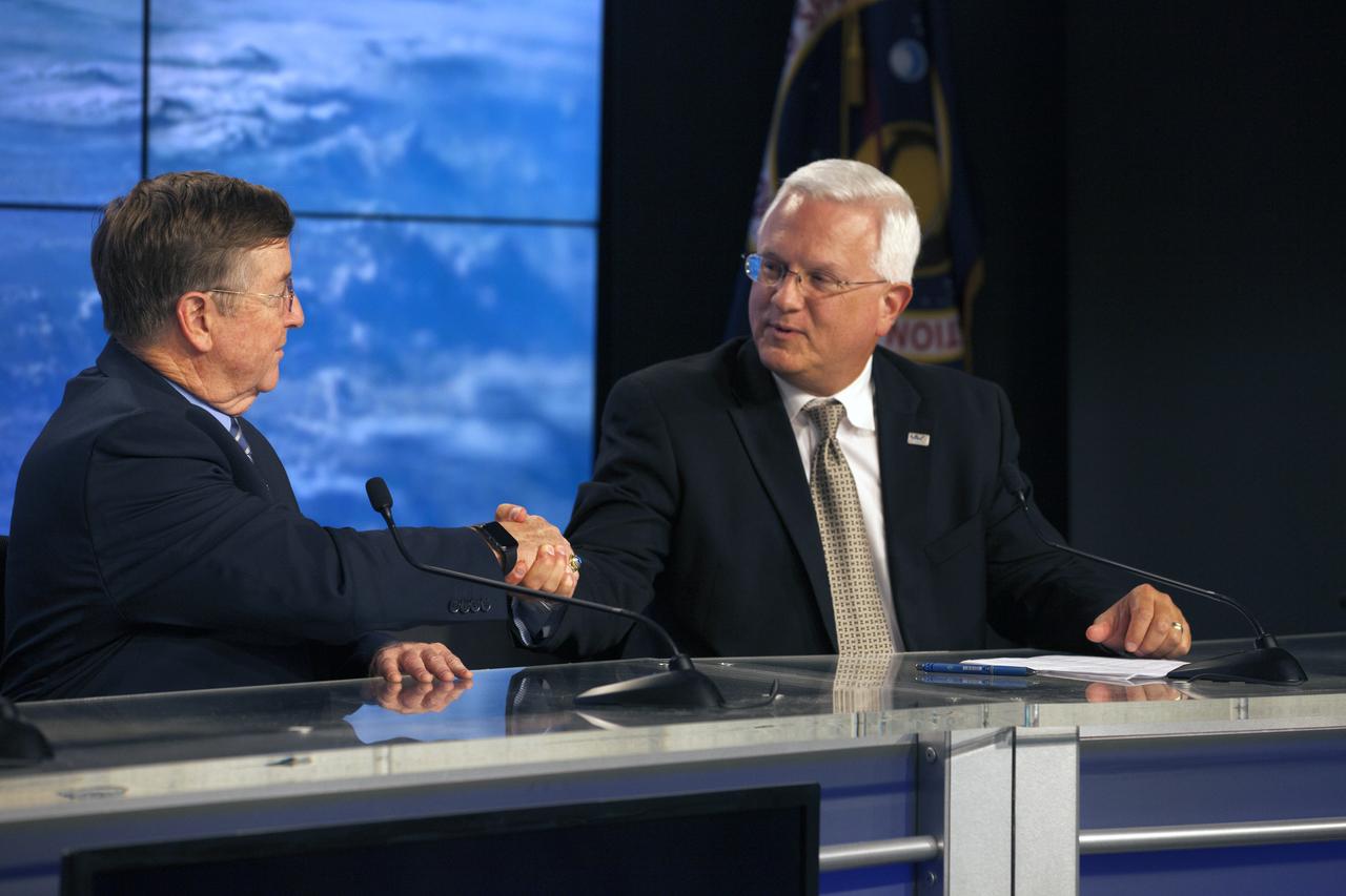 Members of the news media attend a press conference at NASA's Kennedy Space Center in Florida, after the launch of the Orbital ATK Cygnus pressurized cargo module atop a United Launch Alliance Atlas V rocket from Space Launch Complex 41 at Cape Canaveral Air Force Station. It was Orbital ATK's seventh commercial resupply services mission to the International Space Station. Liftoff was at 11:11 a.m. EDT. Shaking hands, from left, are Frank Culbertson, president, Orbital ATK Space Systems Group.and Vern Thorp, program manager, commercial missions, United Launch Alliance.