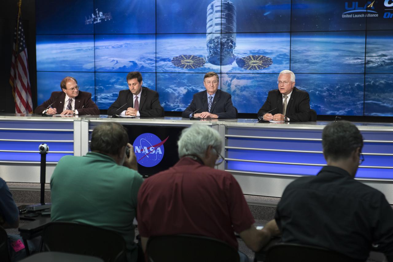 Members of the news media attend a press conference at NASA's Kennedy Space Center in Florida, after the launch of the Orbital ATK Cygnus pressurized cargo module atop a United Launch Alliance Atlas V rocket from Space Launch Complex 41 at Cape Canaveral Air Force Station. It was Orbital ATK's seventh commercial resupply services mission to the International Space Station. Liftoff was at 11:11 a.m. EDT. Speaking to the media are, from left, George Diller, NASA Kennedy Communications; Joel Montalbano, deputy manager, International Space Station Program, NASA Johnson Space Center in Houston; Frank Culbertson, president, Orbital ATK Space Systems Group; and Vern Thorp, program manager, commercial missions, United Launch Alliance.