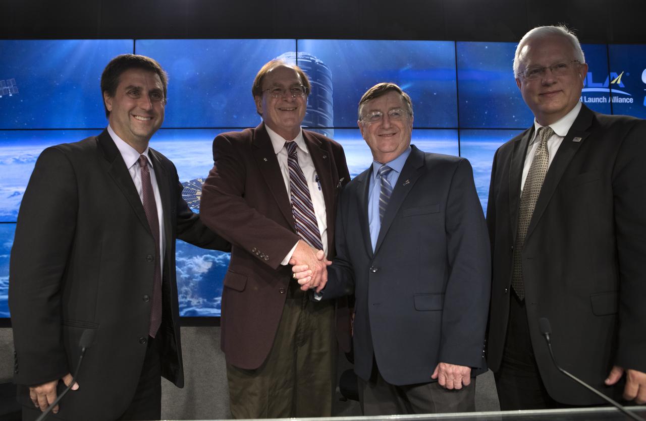 At the conclusion of the Orbital ATK CRS-7 post-launch press conference, moderator George Diller, second from left, NASA Kennedy Communications; shakes hands with Joel Montalbano, deputy manager, International Space Station Program, NASA Johnson Space Center in Houston. Also with them are Frank Culbertson, president, Orbital ATK Space Systems Group; and Vern Thorp, program manager, commercial missions, United Launch Alliance. A United Launch Alliance Atlas V rocket lifted off from Space Launch Complex 41 at Cape Canaveral Air Force Station in Florida, carrying Orbital ATK's Cygnus pressurized cargo module. It is Orbital ATK's seventh commercial resupply services mission to the International Space Station. Liftoff was at 11:11 a.m. EDT.