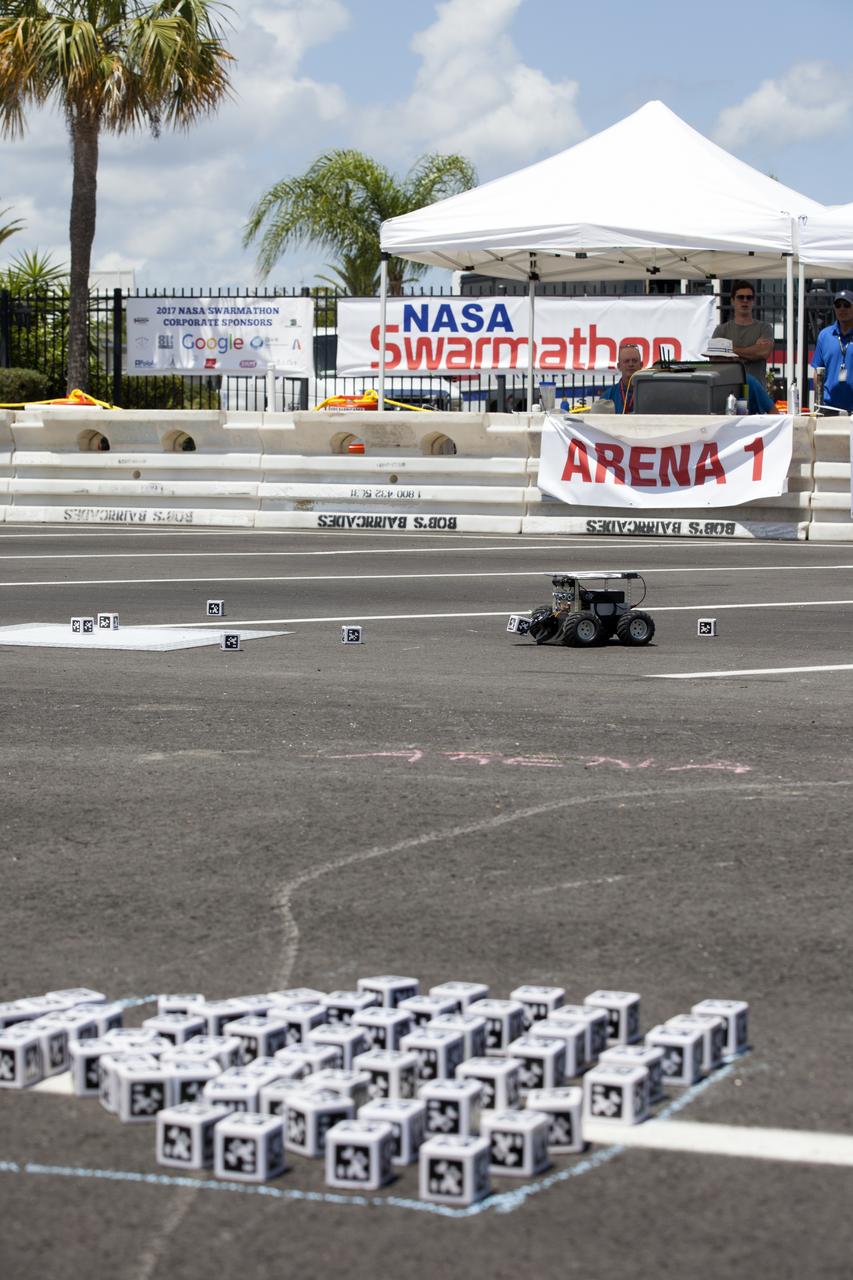 In the Swarmathon competition at the Kennedy Space Center Visitor Complex, students were asked to develop computer code for the small robots, programming them to look for "resources" in the form of AprilTag cubes, similar to barcodes. Teams developed search algorithms for the Swarmies to operate autonomously, communicating and interacting as a collective swarm similar to ants foraging for food. In the spaceport's second annual Swarmathon, 20 teams representing 22 minority serving universities and community colleges were invited to develop software code to operate these innovative robots known as "Swarmies" to help find resources when astronauts explore distant locations, such as the moon or Mars.