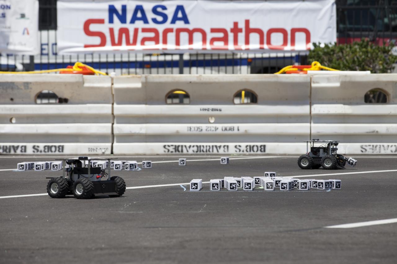 In the Swarmathon competition at the Kennedy Space Center Visitor Complex, students were asked to develop computer code for the small robots, programming them to look for "resources" in the form of AprilTag cubes, similar to barcodes. Teams developed search algorithms for the Swarmies to operate autonomously, communicating and interacting as a collective swarm similar to ants foraging for food. In the spaceport's second annual Swarmathon, 20 teams representing 22 minority serving universities and community colleges were invited to develop software code to operate these innovative robots known as "Swarmies" to help find resources when astronauts explore distant locations, such as the moon or Mars.