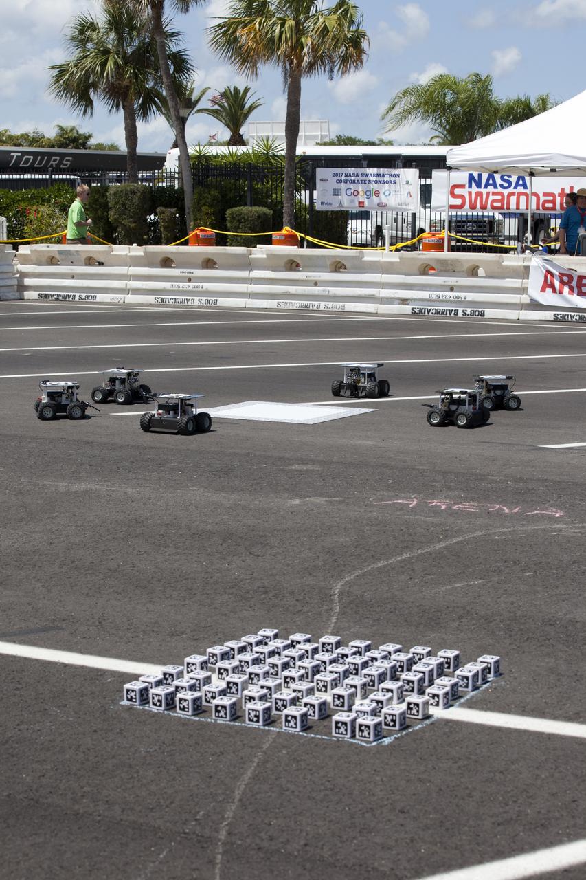 In the Swarmathon competition at the Kennedy Space Center Visitor Complex, students were asked to develop computer code for the small robots, programming them to look for "resources" in the form of AprilTag cubes, similar to barcodes. Teams developed search algorithms for the Swarmies to operate autonomously, communicating and interacting as a collective swarm similar to ants foraging for food. In the spaceport's second annual Swarmathon, 20 teams representing 22 minority serving universities and community colleges were invited to develop software code to operate these innovative robots known as "Swarmies" to help find resources when astronauts explore distant locations, such as the moon or Mars.