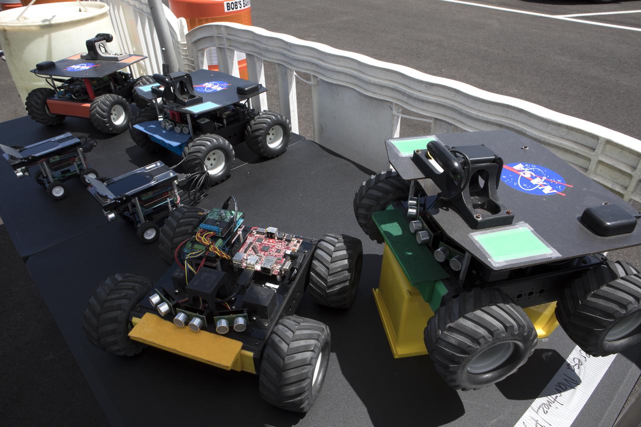 A display at the Kennedy Space Center Visitor Complex describes the purpose of Swarmies. Computer scientists are developing these robots focusing not so much on the hardware, but the software. In the spaceport's annual Swarmathon, students from 12 colleges and universities across the nation were invited to develop software code to operate Swarmies to help find resources when astronauts explore distant planets, such as Mars.