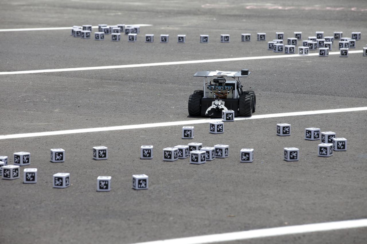 In the Swarmathon competition at the Kennedy Space Center Visitor Complex, students were asked to develop computer code for the small robots, programming them to look for "resources" in the form of cubes with AprilTags, similar to barcodes. Teams developed search algorithms for innovative robots known as "Swarmies" to operate autonomously, communicating and interacting as a collective swarm similar to ants foraging for food. In the spaceport's second annual Swarmathon, 20 teams representing 22 minority serving universities and community colleges were invited to participate. Similar robots could help find resources when astronauts explore distant locations, such as the moon or Mars.