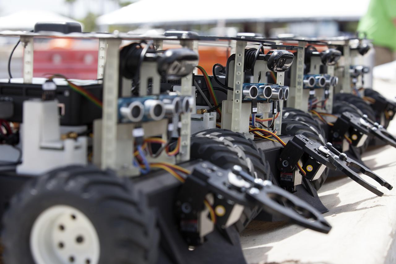 This close-up shows Swarmie robots that were programmed with computer code by college and university students. During the Swarmathon competition at the Kennedy Space Center Visitor Complex, the small robots looked for "resources" in the form of cubes with AprilTags, similar to barcodes. Similar robots could help find resources when astronauts explore distant locations, such as the moon or Mars.